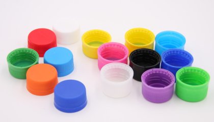 What are the processes for producing plastic bottle caps?