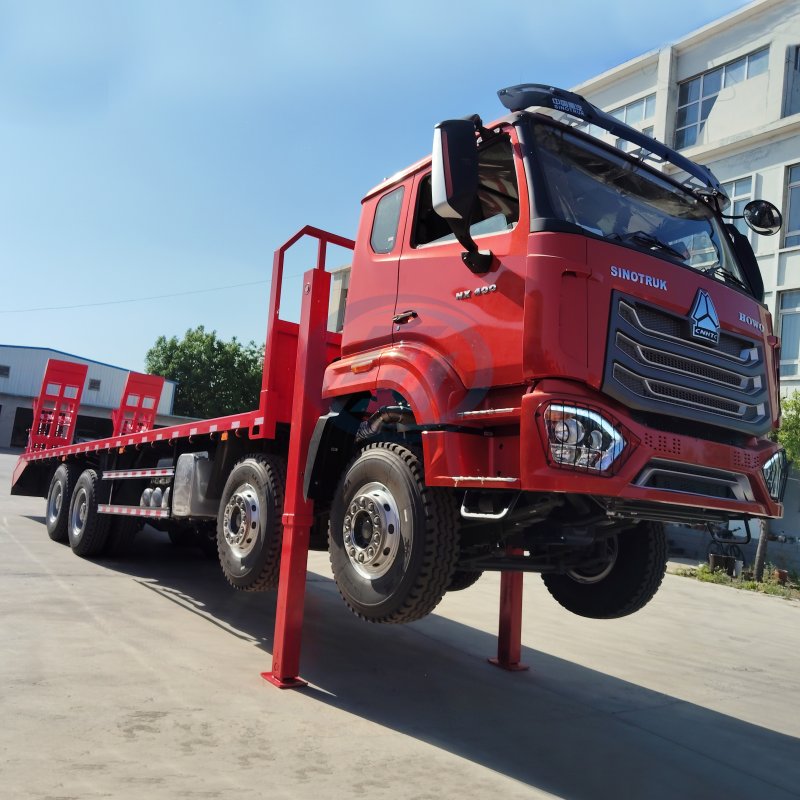 HOWO NX 8X4 FLATED CARGO TRUCK WITH FRONT LIFTING OUTTRIGGER AND REAR LADDER